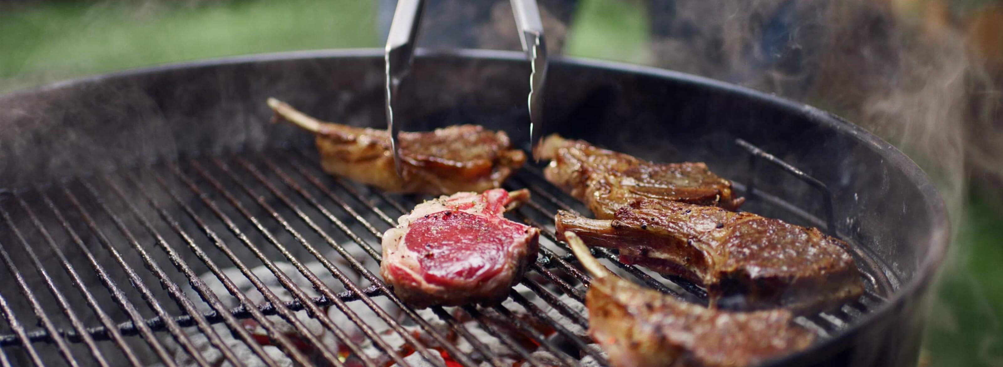 Lamb chops cooking on a charcoal grill