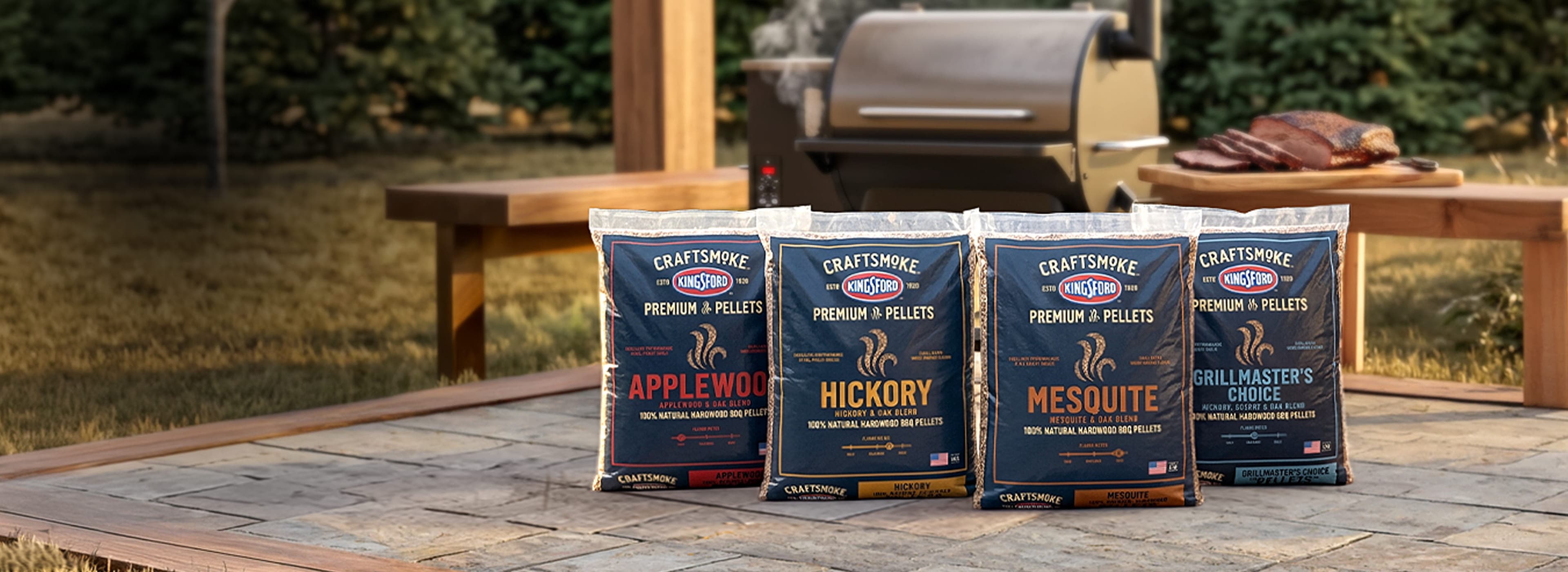 Kingsford Craftsmoke wood pellets in four varieties beside a pellet grill.